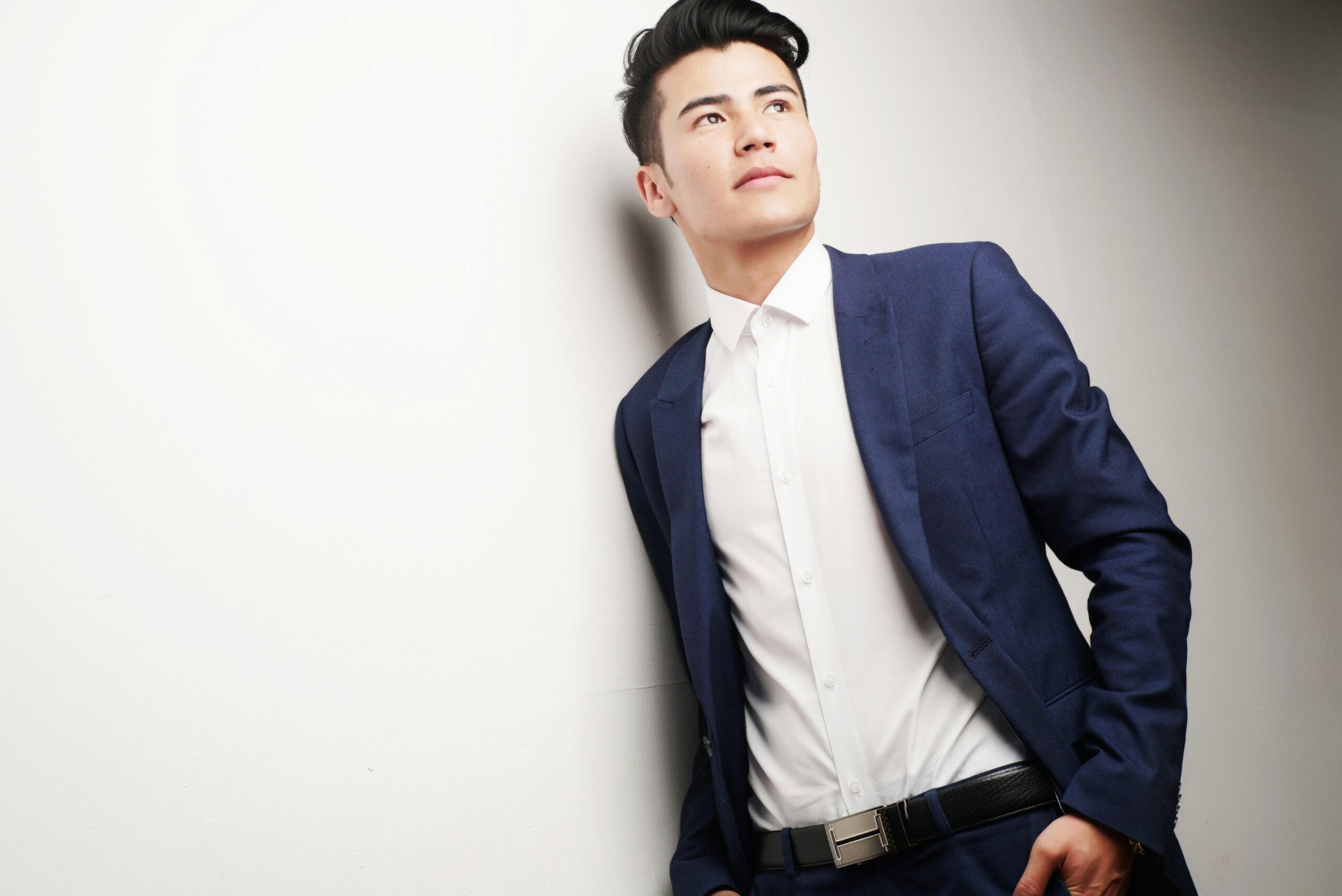 Elegant businessman in a blue suit looking thoughtful, ideal for corporate themes.